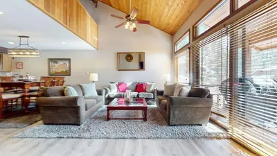 a living room with two couches and a table at Woodlands #33 Condo in Mammoth Lakes