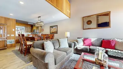 a living room with a couch and a table at Woodlands #33 Condo in Mammoth Lakes