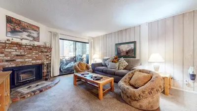 a living room with a couch and a fireplace at Summit Condominium #273 Condo in Mammoth Lakes