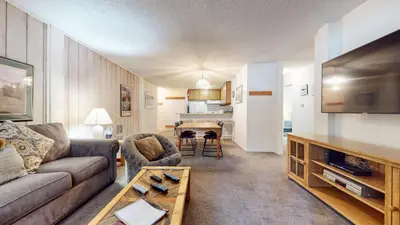 a living room with a couch and a table at Summit Condominium #273 Condo in Mammoth Lakes