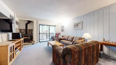 a living room with two couches and a television at Summit Condominium #41 Condo in Mammoth Lakes