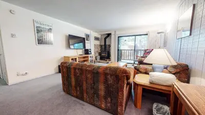 a living room with two couches and a table at Summit Condominium #41 Condo in Mammoth Lakes