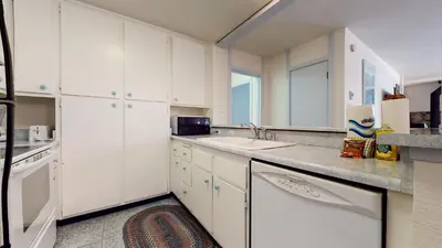 a kitchen with white cabinets and a sink at Summit Condominium #41 Condo in Mammoth Lakes