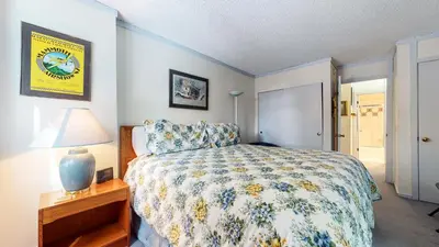 a bedroom with a bed and a lamp on a table at Summit Condominium #41 Condo in Mammoth Lakes