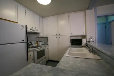 a kitchen with a sink and a white refrigerator at Summit Condominium #41 Condo in Mammoth Lakes