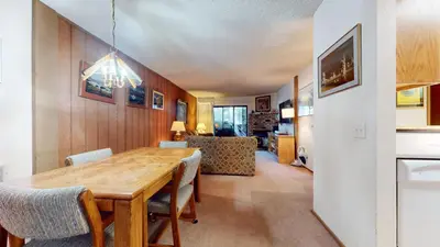 a dining room with a wooden table and chairs at Summit Condominium #267 Condo in Mammoth Lakes
