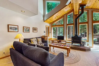 a living room with a couch and a table at Happy Family Cozy Cabin in Truckee