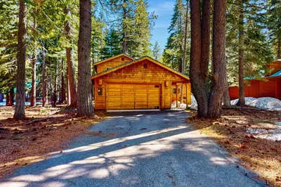 a log cabin in the middle of a forest at Happy Family Cozy Cabin in Truckee
