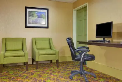 a waiting room with two chairs and a computer monitor at Holiday Inn Express Oakdale by IHG in Oakdale