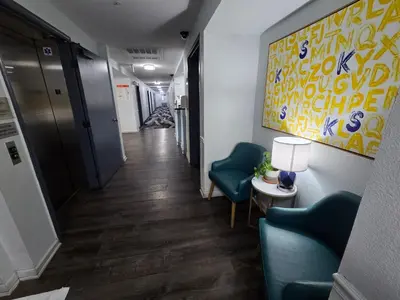 a hallway of an office with two chairs and a lamp at Quality Inn & Suites Tulare in Tulare