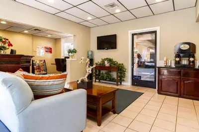 a living room with a couch and a table at Auburn House Hotel in Auburn