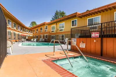 a building with a swimming pool in a courtyard at Auburn House Hotel in Auburn