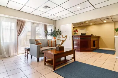 a waiting room with a couch and a table at Auburn House Hotel in Auburn