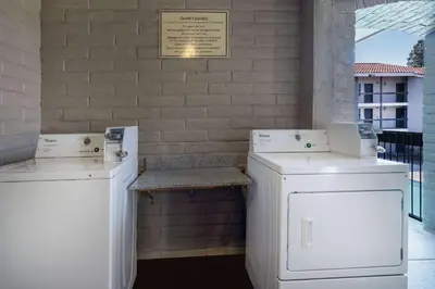 two white washing machines sitting next to a brick wall at La Quinta Inn by Wyndham Sacramento North in Sacramento