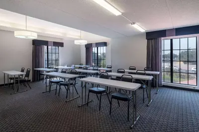 a large room with tables and chairs and windows at La Quinta Inn by Wyndham Sacramento North in Sacramento