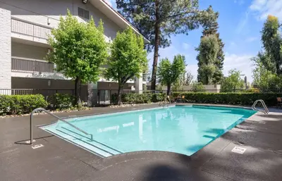 a swimming pool in front of a building at La Quinta Inn by Wyndham Stockton in Stockton