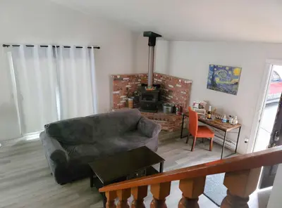 a living room with a couch and a fireplace at NEW! Cozy & Secluded House w/Deck - Near Yosemite! in Tuolumne