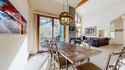 a dining room with a wooden table and chairs at Snowcreek 880 Condo in Mammoth Lakes