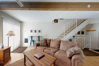 a living room with a couch and a staircase at Mammoth View Villas 21 in Mammoth Lakes