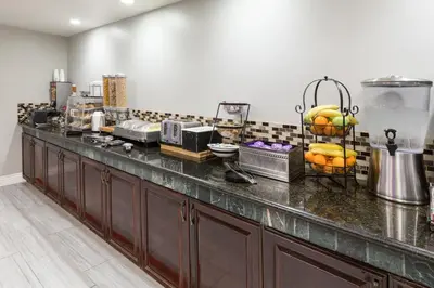 a kitchen with a counter with fruit on it at La Quinta by Wyndham Visalia/Sequoia Gateway in Visalia