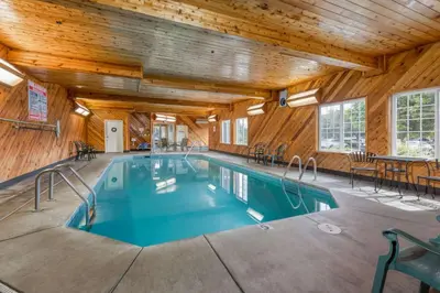 a pool in a building with a wooden ceiling at La Quinta by Wyndham Visalia/Sequoia Gateway in Visalia