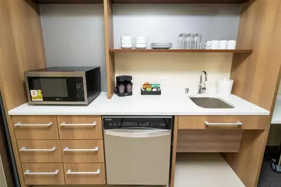 a small kitchen with a sink and a microwave at Home2 Suites By Hilton Roseville Sacramento in Roseville