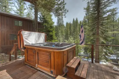 a hot tub on the deck of a cabin at Serventi Tahoe Donner Cabin in Truckee