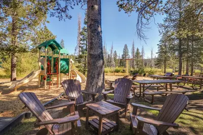 a park with tables and chairs and a playground at Serventi Tahoe Donner Cabin in Truckee