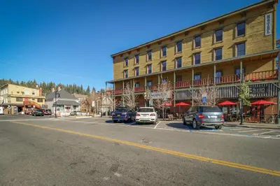 a street with cars parked in front of a building at Serventi Tahoe Donner Cabin in Truckee