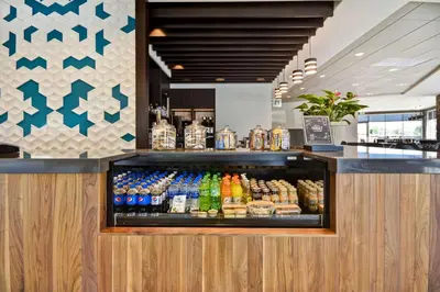 a display case in a restaurant with drinks at Hyatt Place Fresno in Fresno