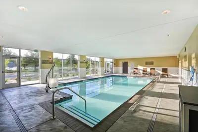 a large pool in a hotel room with windows at Hyatt Place Fresno in Fresno