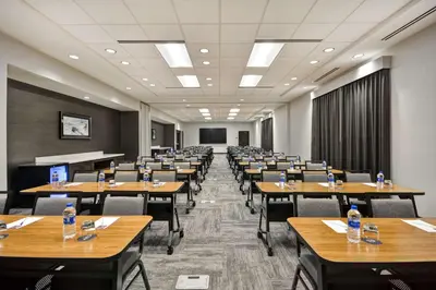 a classroom with tables and chairs in a room at Hyatt Place Fresno in Fresno