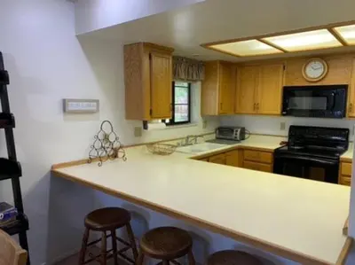 a kitchen with a counter and stools in it at Rr-interlaken 13 in June Lake