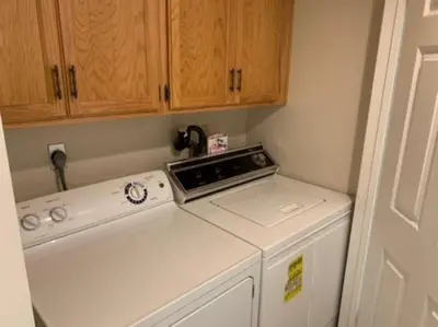 a kitchen with a washing machine and wooden cabinets at Rr-interlaken 13 in June Lake