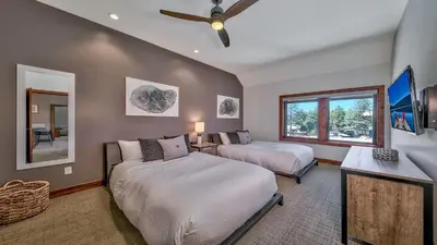 a bedroom with two beds and a window at Luxury Residence - Gondola Across The Street Condo in South Lake Tahoe