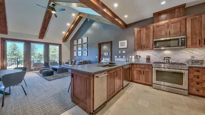 a large kitchen with wooden cabinets and a dining room at Luxury Residence - Gondola Across The Street Condo in South Lake Tahoe