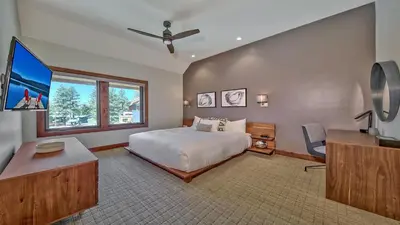 a bedroom with a bed and a large window at Luxury Residence - Gondola Across The Street Condo in South Lake Tahoe