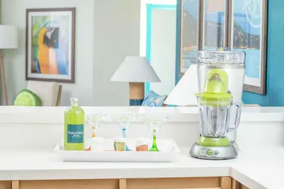 a blender on a counter with glasses and a bottle of wine at Margaritaville Resort Lake Tahoe in South Lake Tahoe