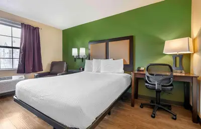 a bedroom with a bed and a desk and a chair at Extended Stay America Suites - Sacramento - Roseville in Roseville