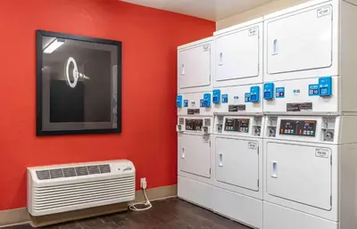 a room with white appliances and a red wall at Extended Stay America Suites - Sacramento - Roseville in Roseville