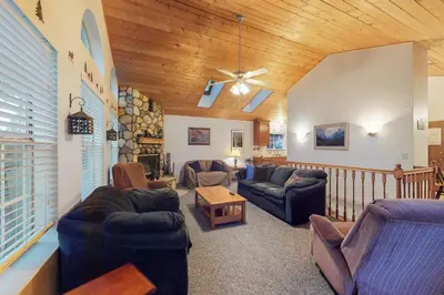 a living room with couches and a wooden ceiling at Escape to Yosemite in Groveland