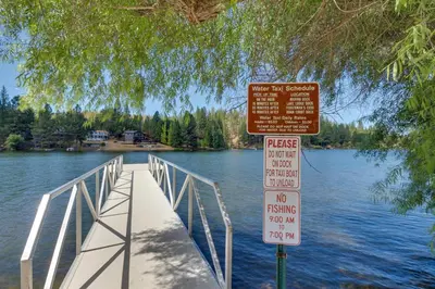 a bridge over a body of water with two signs at Escape to Yosemite in Groveland