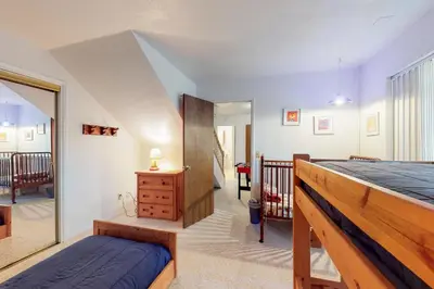 a bedroom with a bed and a staircase at Escape to Yosemite in Groveland