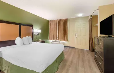 a hotel room with a large bed and a flat screen tv at Extended Stay America Suites - Fresno - North in Fresno