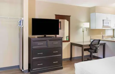 a room with a television on a dresser with a desk at Extended Stay America Suites - Fresno - North in Fresno