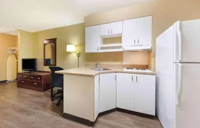 a kitchen with white cabinets and a white refrigerator at Extended Stay America Suites - Fresno - North in Fresno