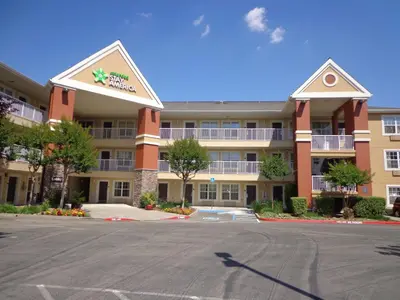 an empty parking lot in front of a hotel at Extended Stay America Suites - Sacramento - White Rock Rd in Rancho Cordova