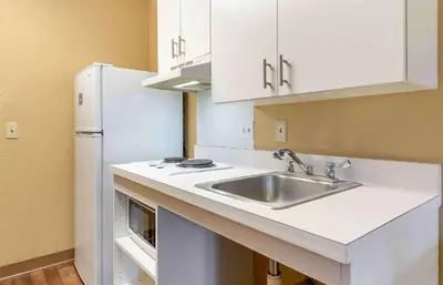 a kitchen with a sink and a refrigerator at Extended Stay America Suites - Sacramento - Arden Way in Sacramento