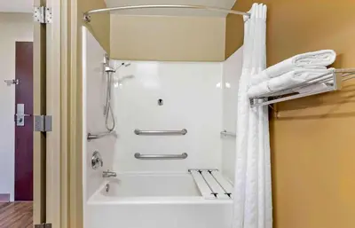 a shower in a bathroom with a white shower curtain at Extended Stay America Suites - Sacramento - Arden Way in Sacramento