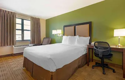 a hotel room with a bed and a desk and a chair at Extended Stay America Suites - Reno - South Meadows in Reno